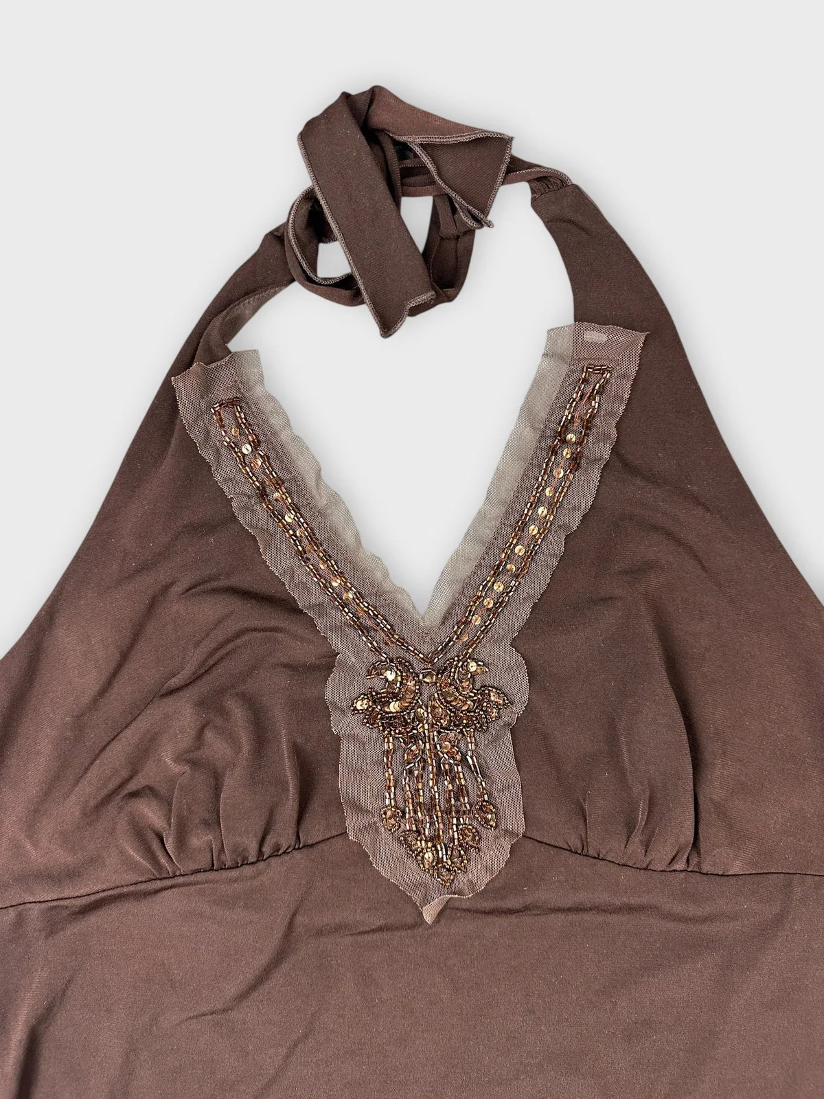 Chic brown halter top with embellished detail view showcasing intricate beading design.
