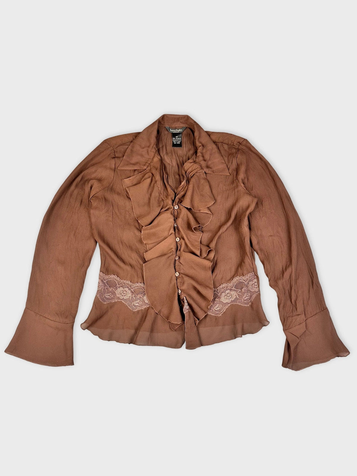 Front view of brown ruffle blouse with lace detail.