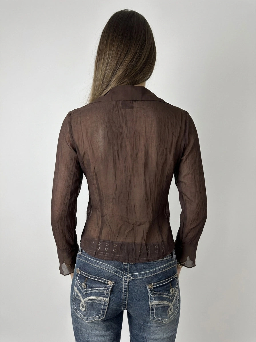 Back view of a brown ruffle blouse with lace trim.