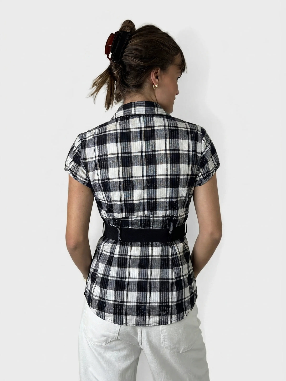 Back view of a short sleeve checkered top in black and white.