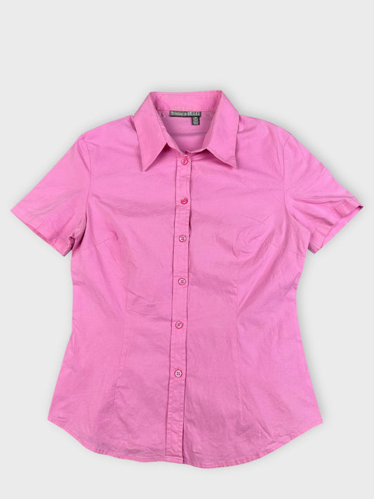 Front view of a pink cotton shirt with short sleeves and buttons.