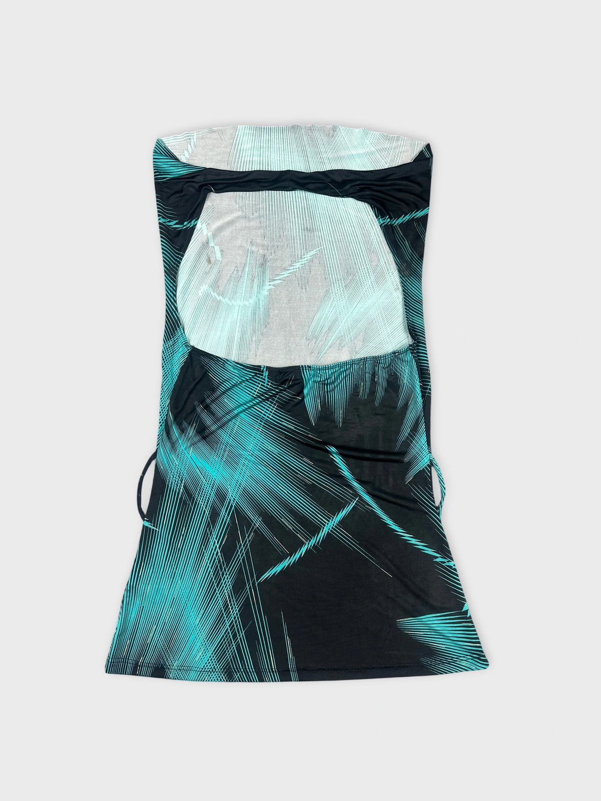Back view of a cowl neck top in black with turquoise geometric patterns.