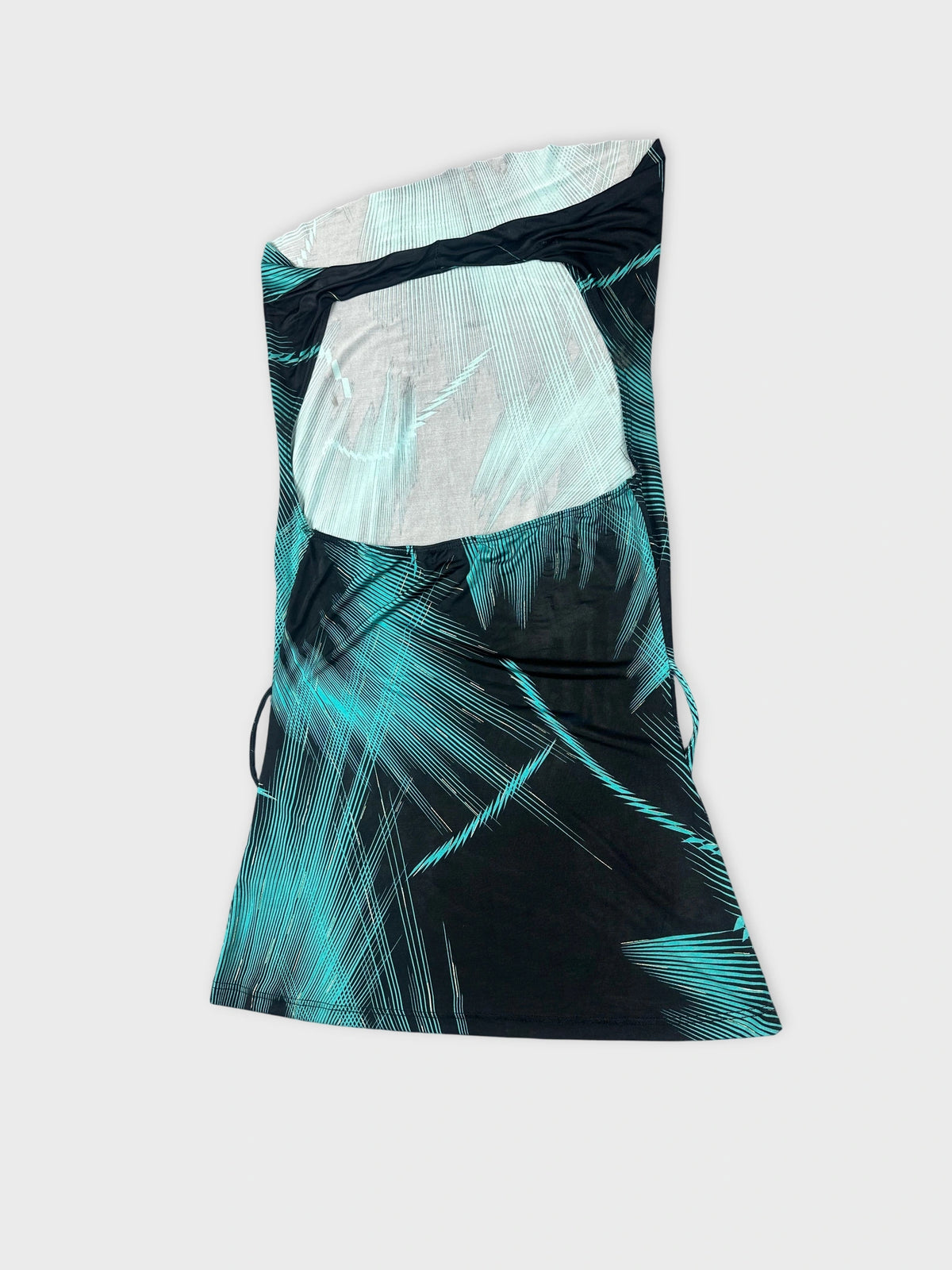 Detail view of a cowl neck top in black with turquoise edgy patterns.