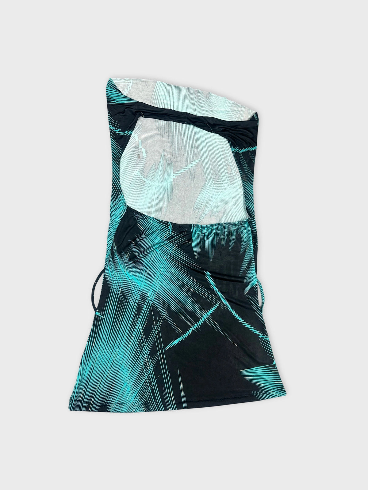 Chic cowl neck top in black with turquoise edgy patterns detail view.