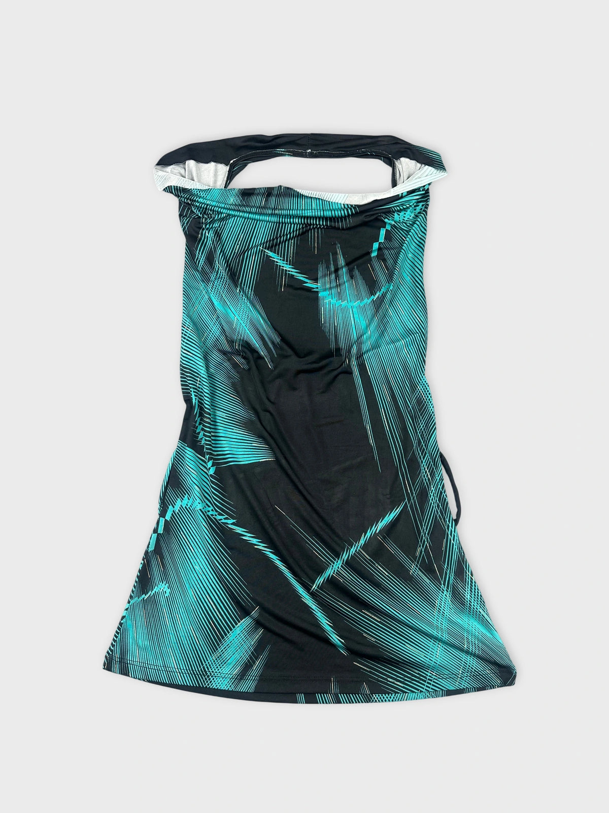 Front view of a black cowl neck top with turquoise edgy patterns.