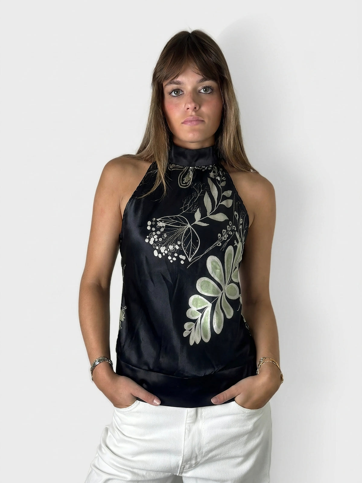 Chic floral satin halter top in black with a unique neckline, front view.