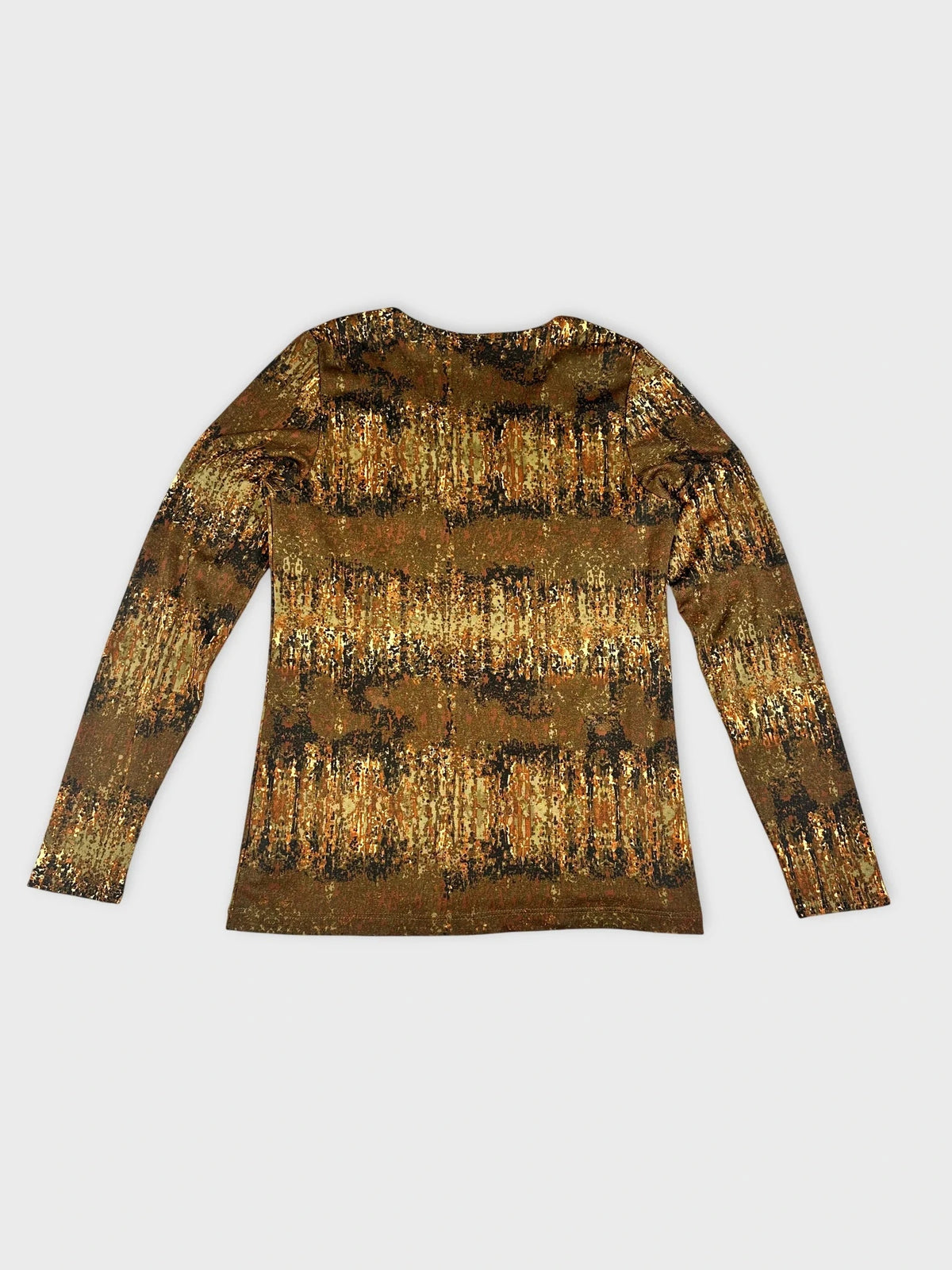 Detail view of a long sleeve top in earthy tones with a nature-inspired print.