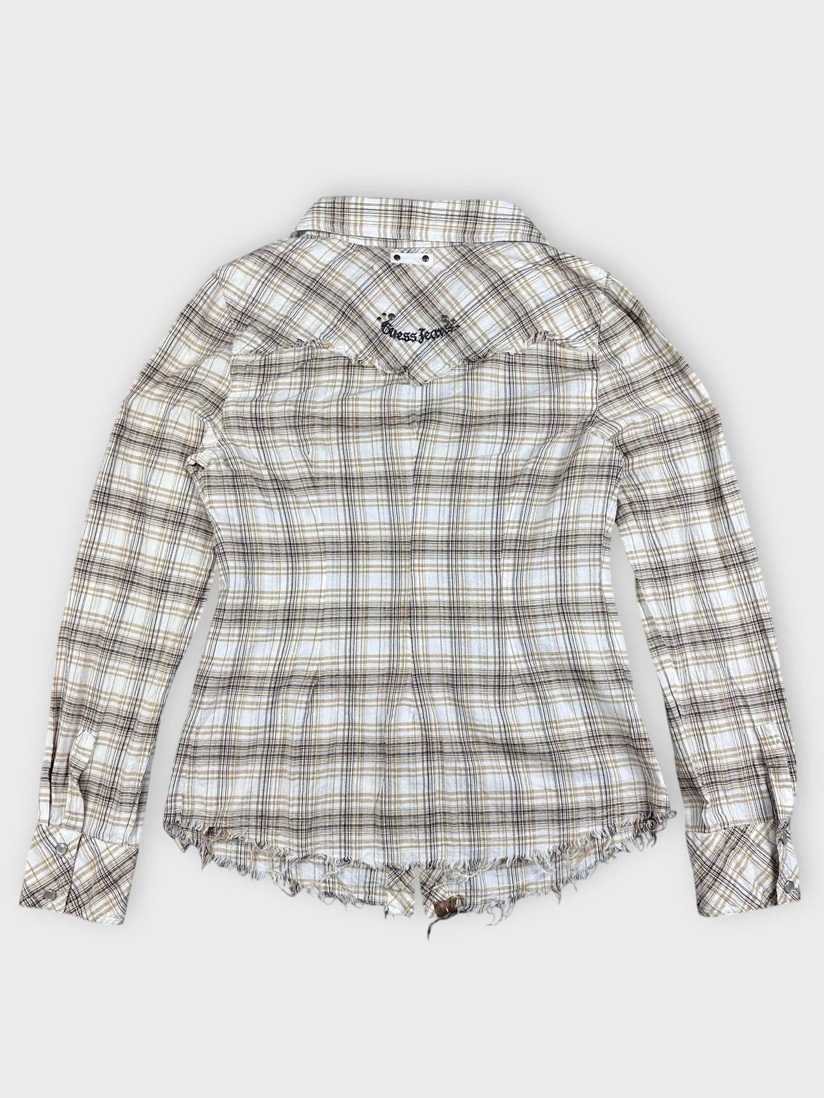 Back view of beige and yellow plaid button-up shirt with frayed hem.