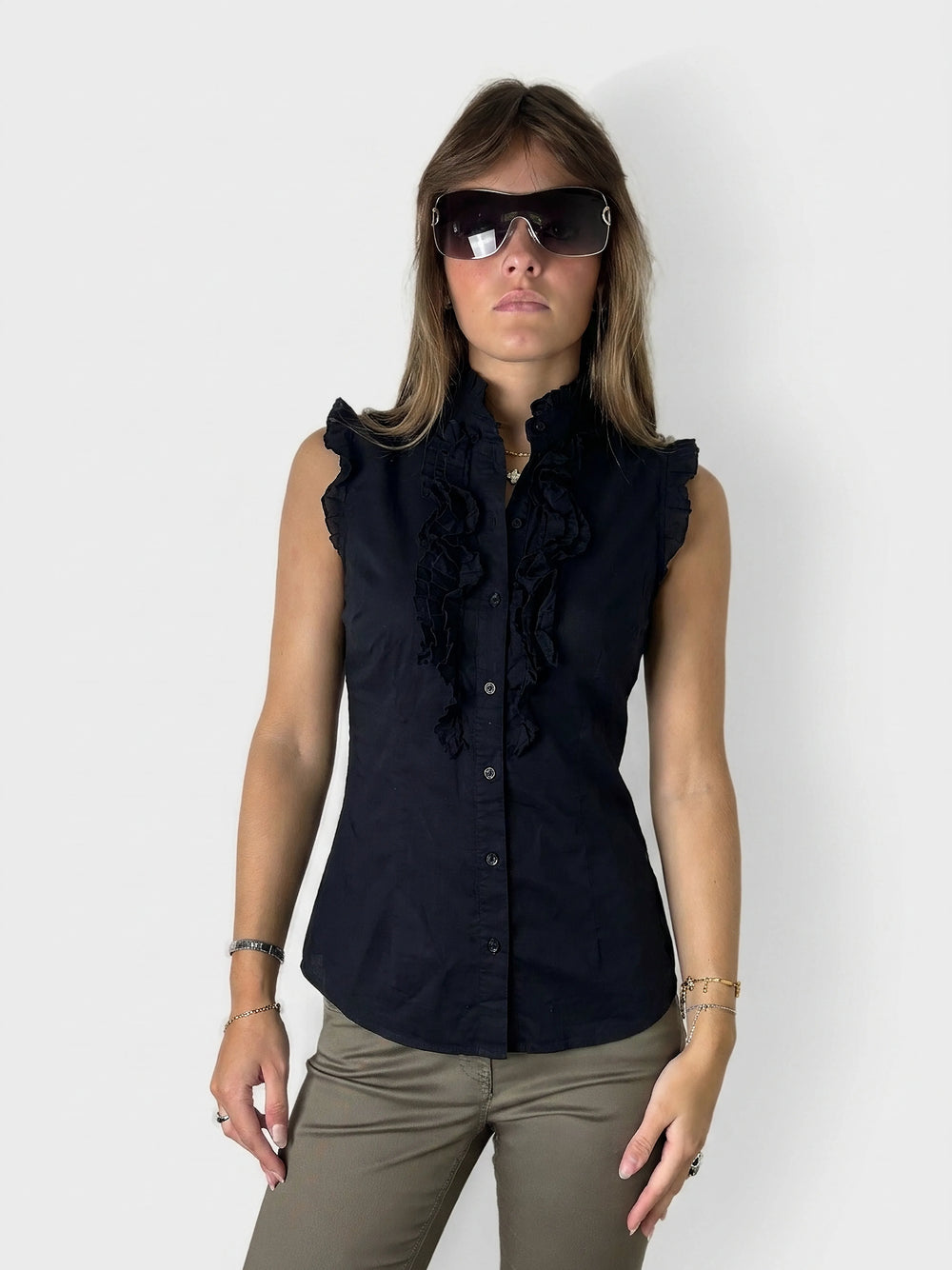 Chic black cotton top with ruffled trim, shown in front view.