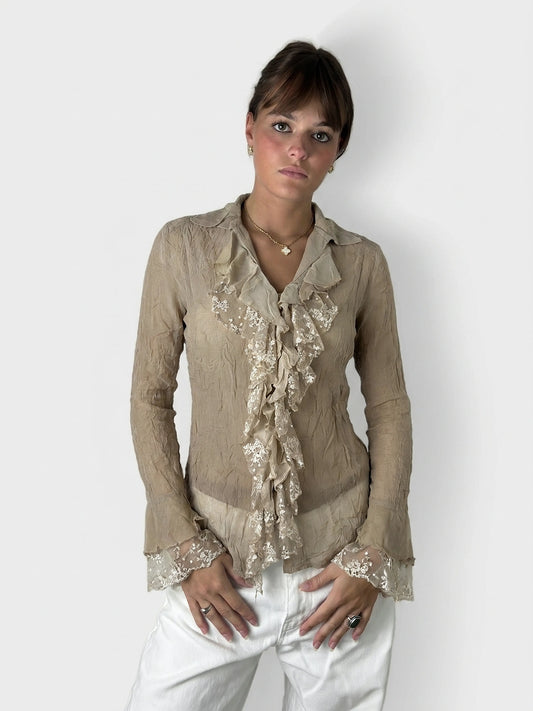 Chic long sleeve top in beige with ruffles, shown in front view.