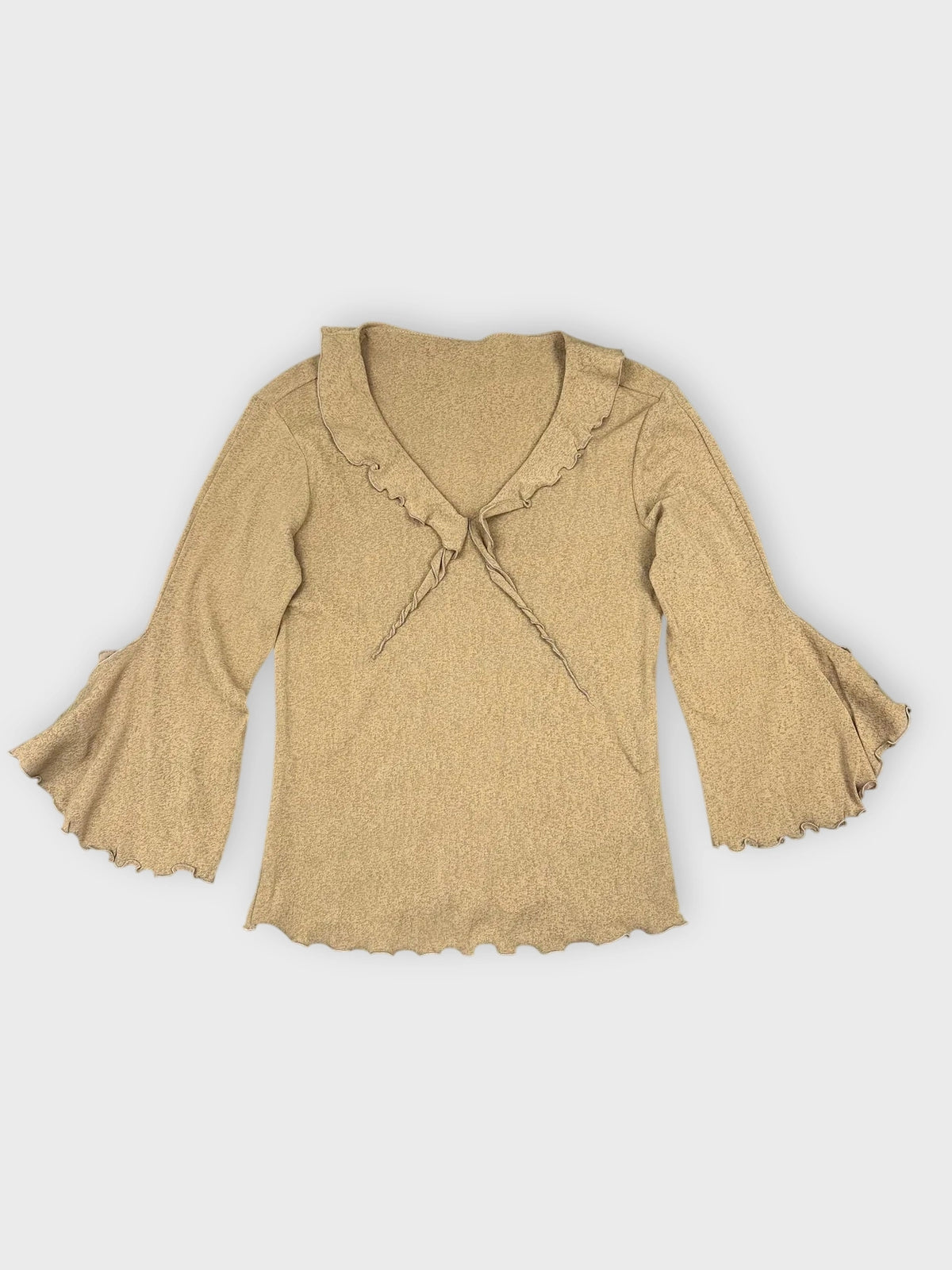 Warm beige long sleeve top with ruffled detail view.