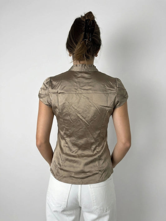 Back view of taupe satin blouse with ruffles detailing.