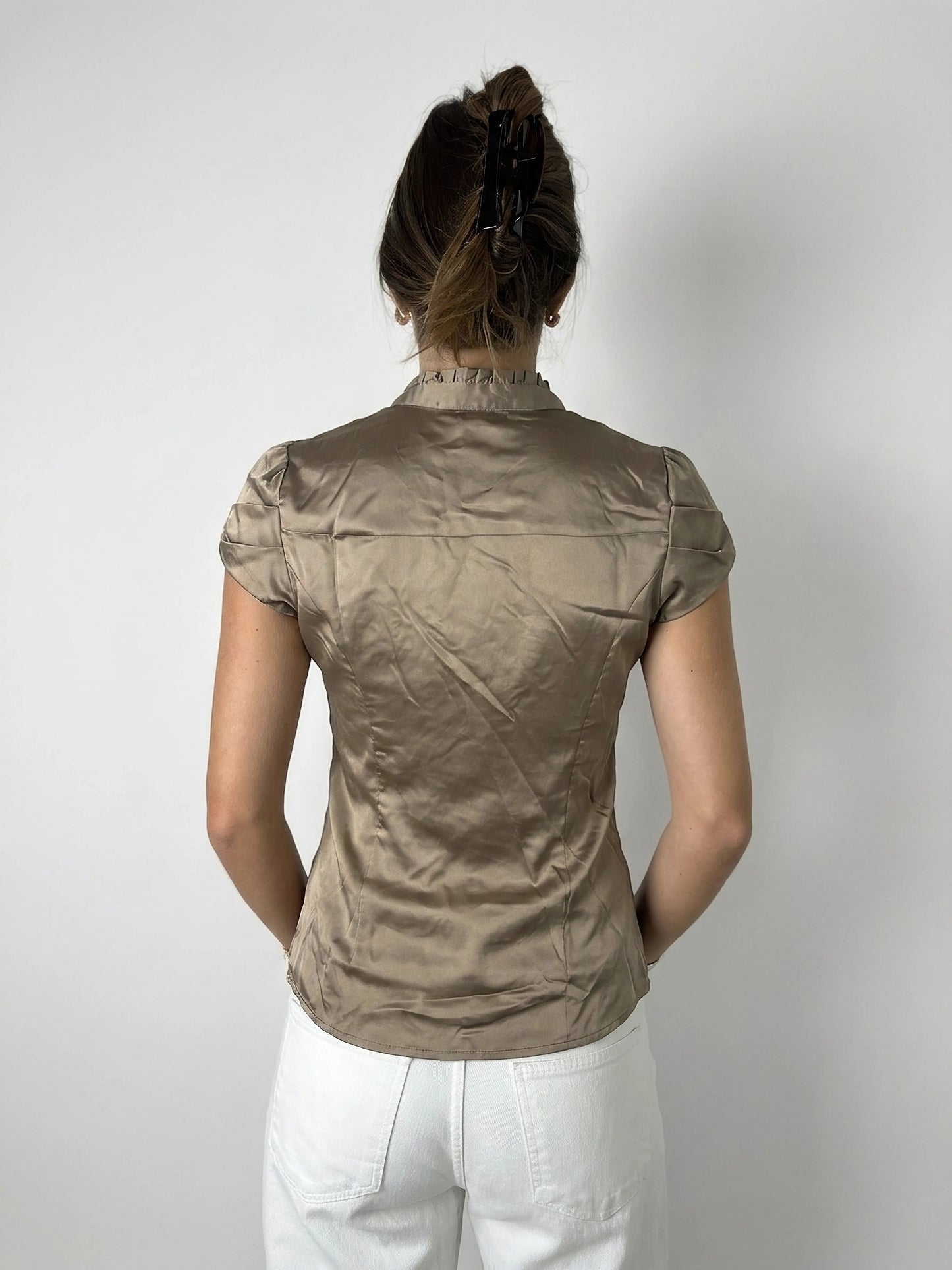 Back view of taupe satin blouse with ruffles detailing.
