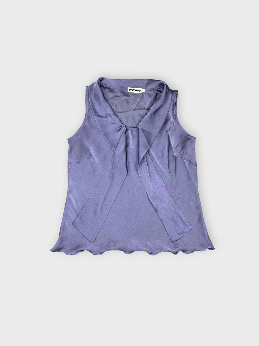 Front view of a sheer purple top with draped details.