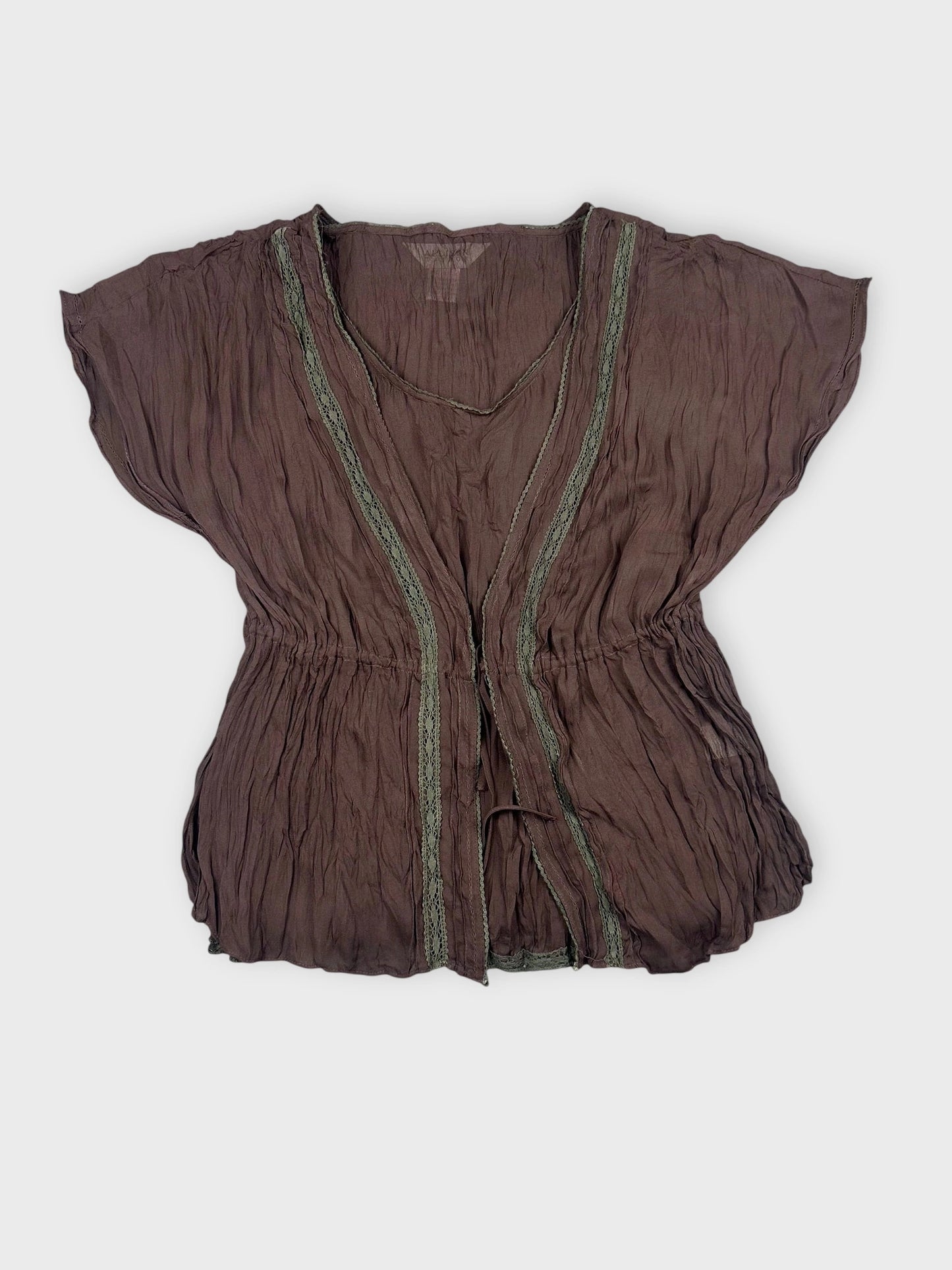 Front view of a chocolate brown sheer ruffled top with lace trim.