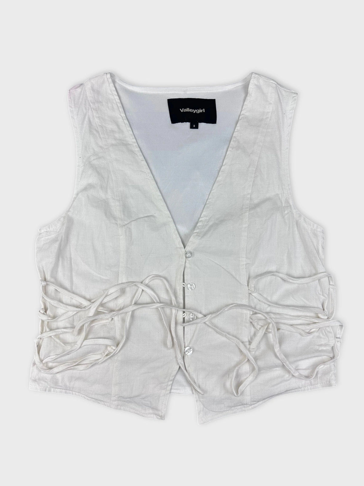 Chic white linen top with lace-up detail front view.