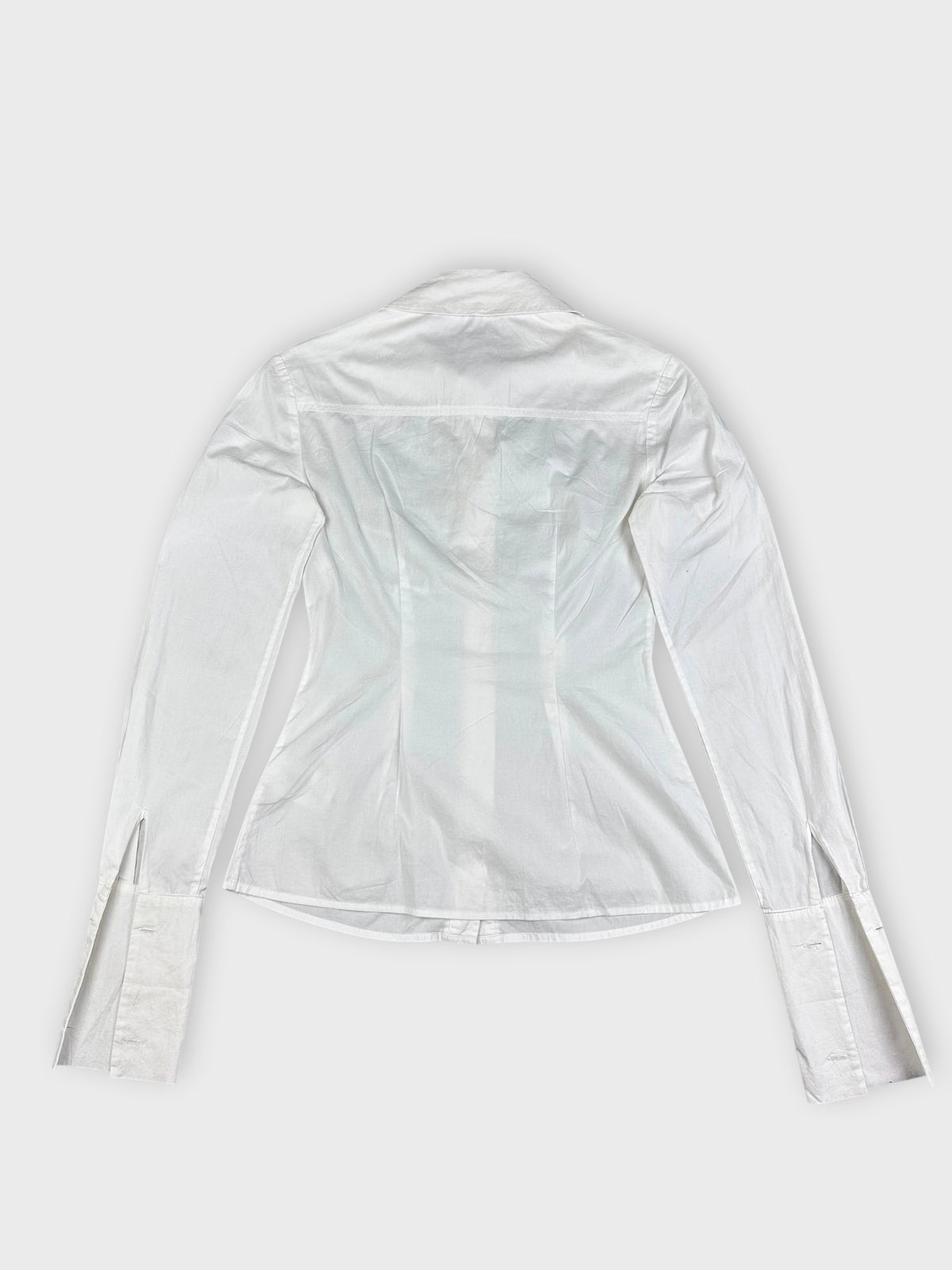 Back view of a white long sleeve button up shirt showing detailed cuffs.