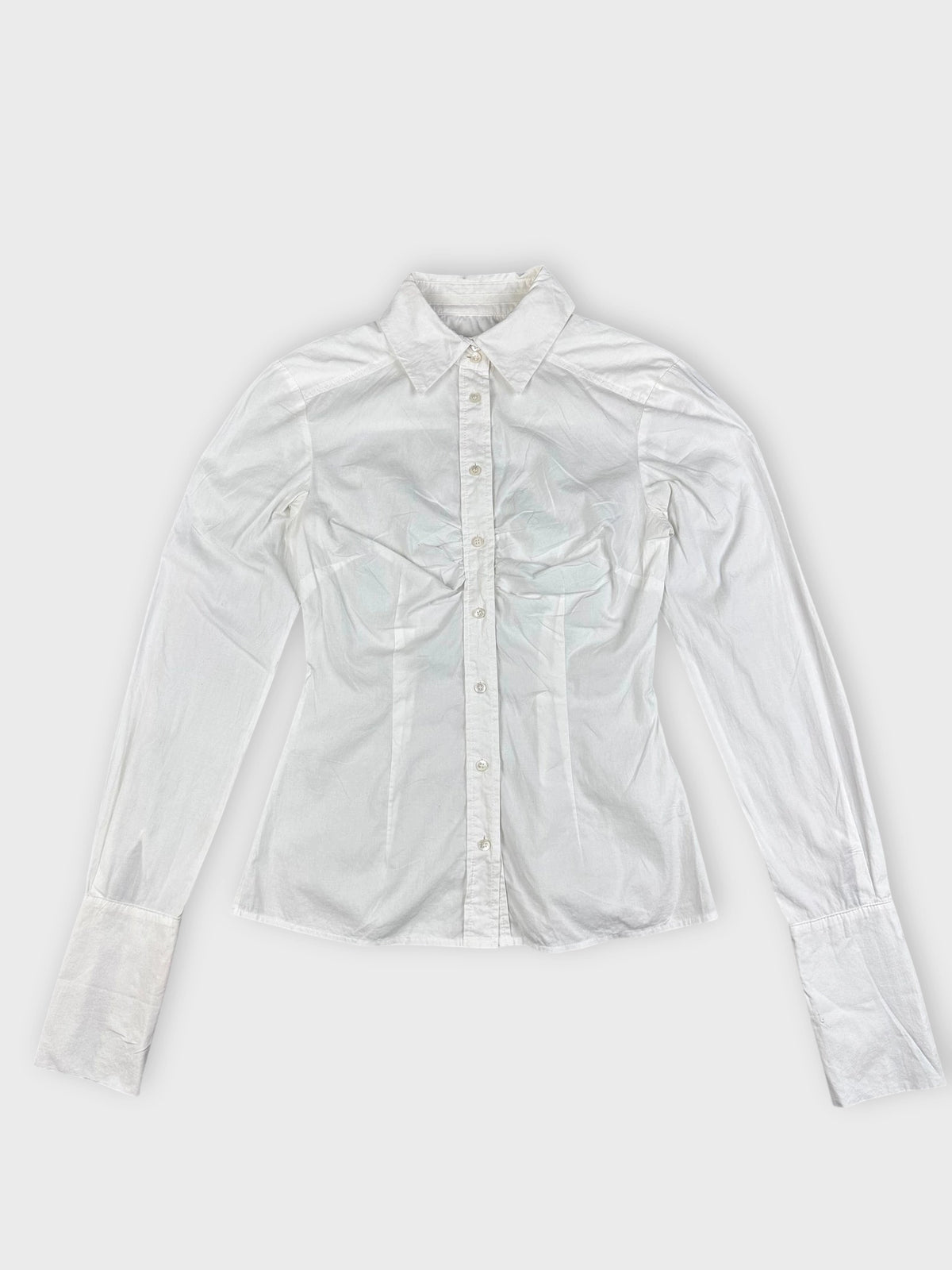 detail view of a white long sleeve button up shirt with a classic collar