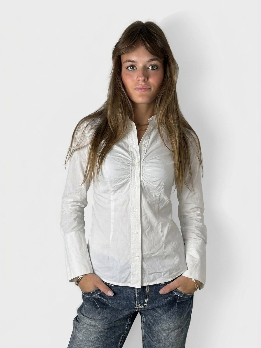 Front view of a white long sleeve button-up shirt with gathered details.