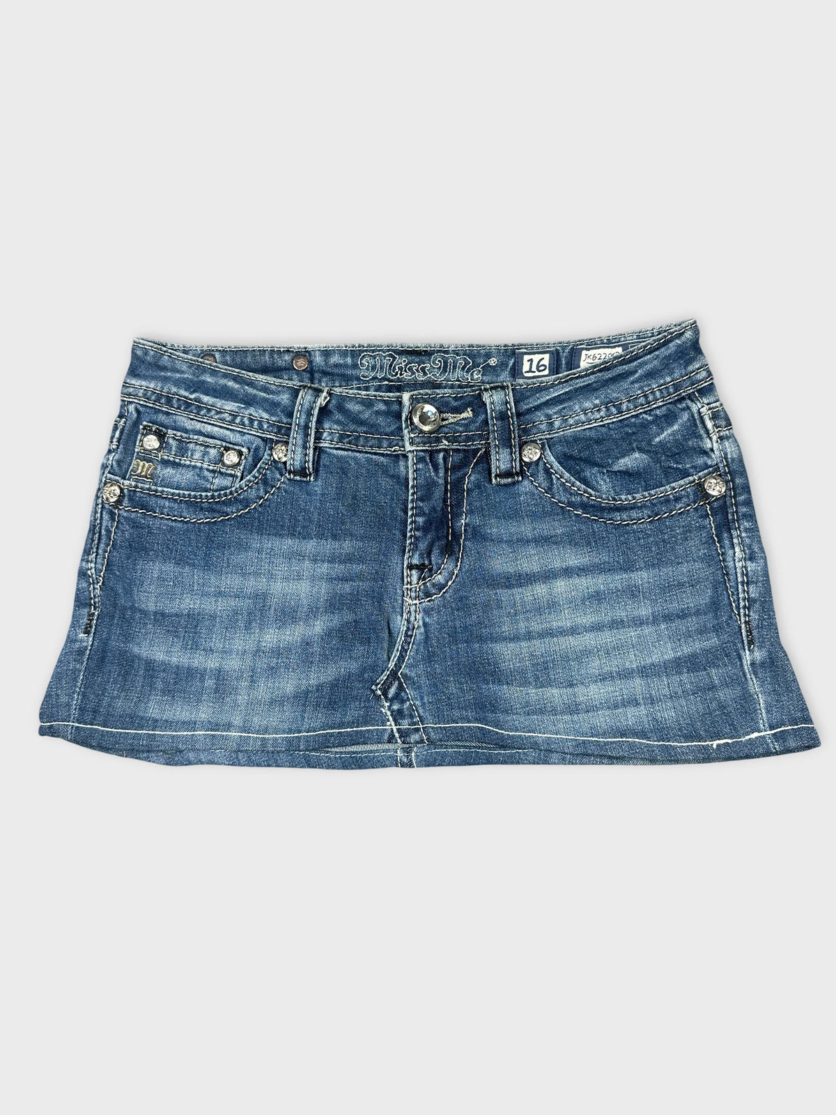 Front view of a blue denim skirt featuring distressed details.