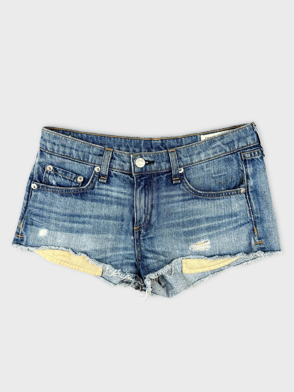 Front view of women's denim shorts in blue with distressed details.