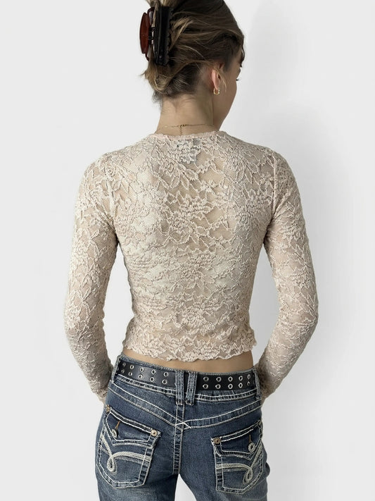 Back view of cream lace crop top featuring sheer details.