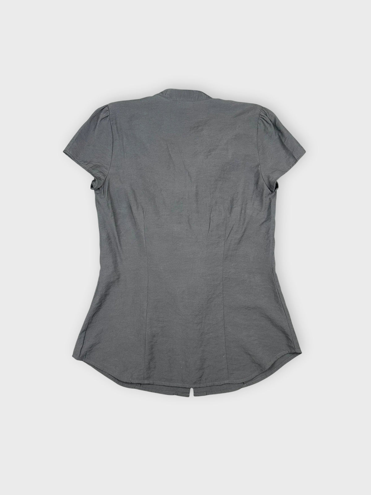Back view of dark gray button-up shirt featuring ruffled details.