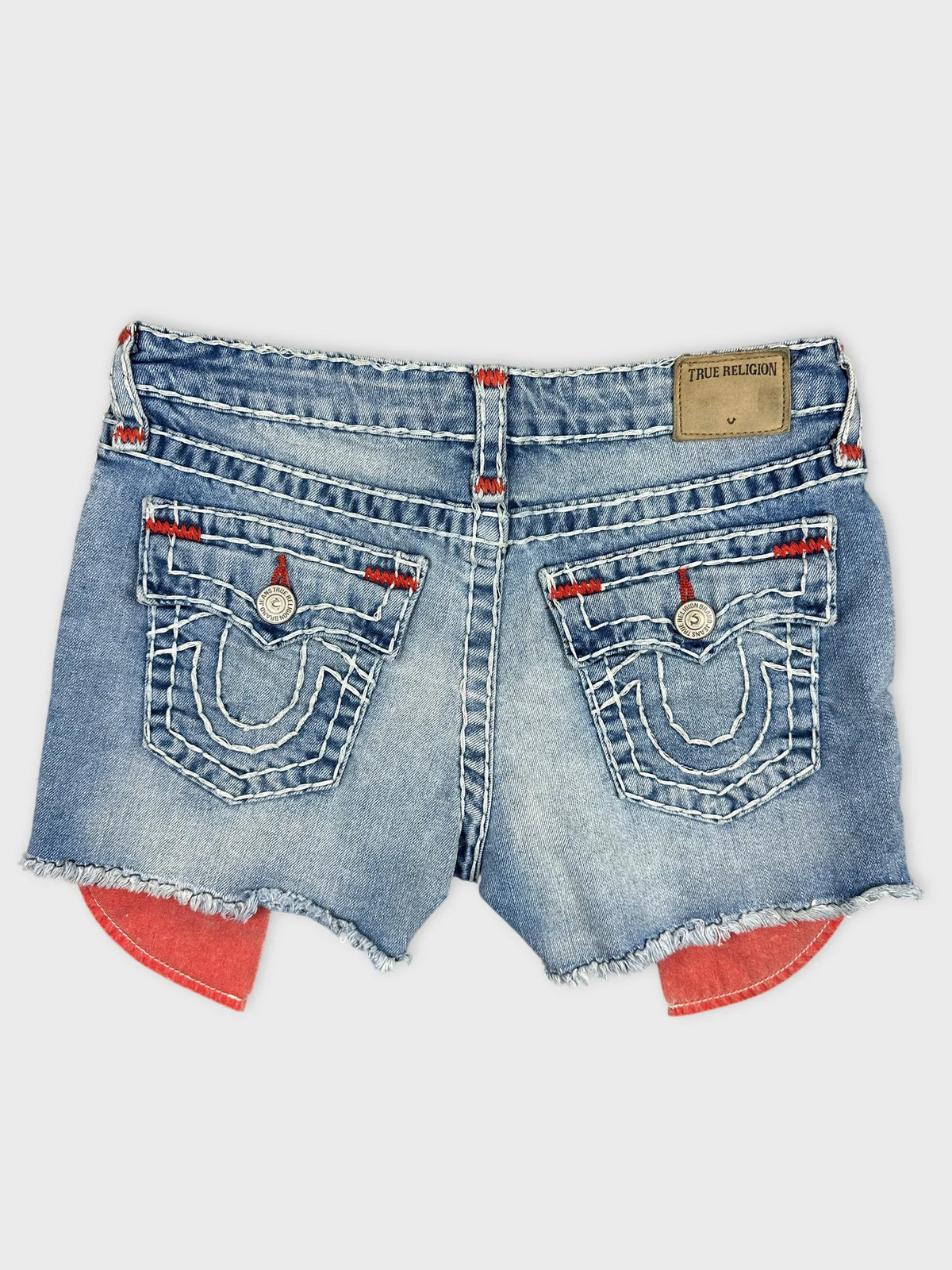 Back view of denim shorts in blue with red stitching detail.