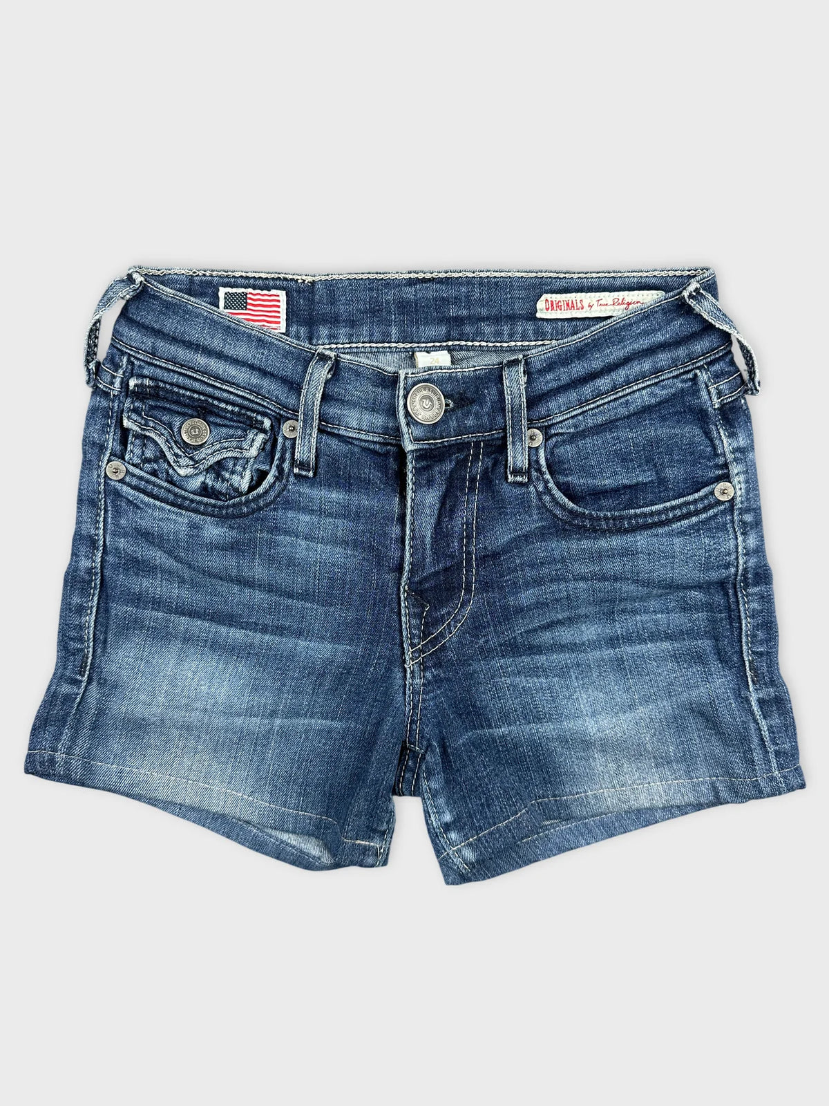 Front view of denim shorts in classic blue with frayed hemline.