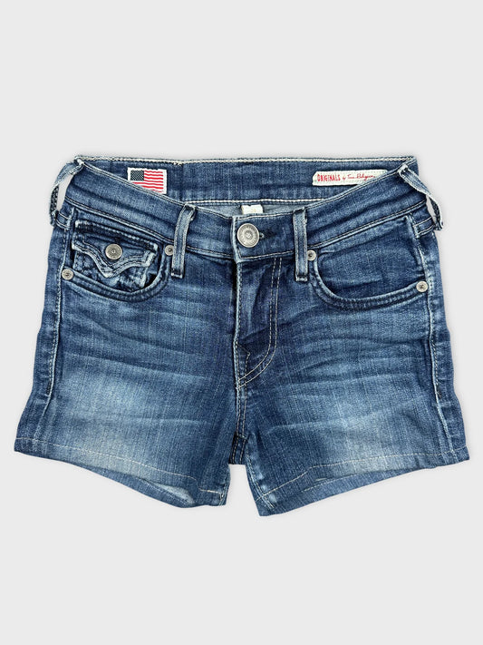 Front view of denim shorts in classic blue with frayed hemline.