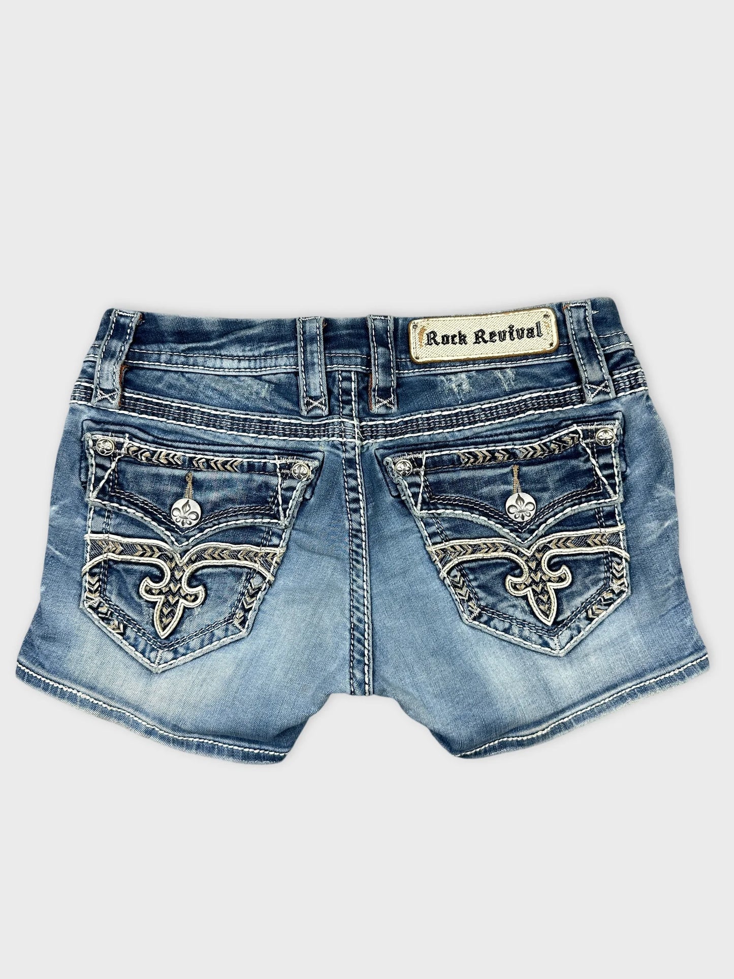 Back view of distressed denim skirt in blue with zip detail.