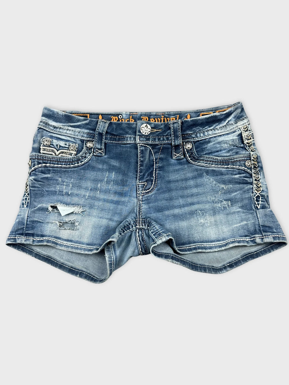 Distressed denim skirt in blue with frayed hem front view