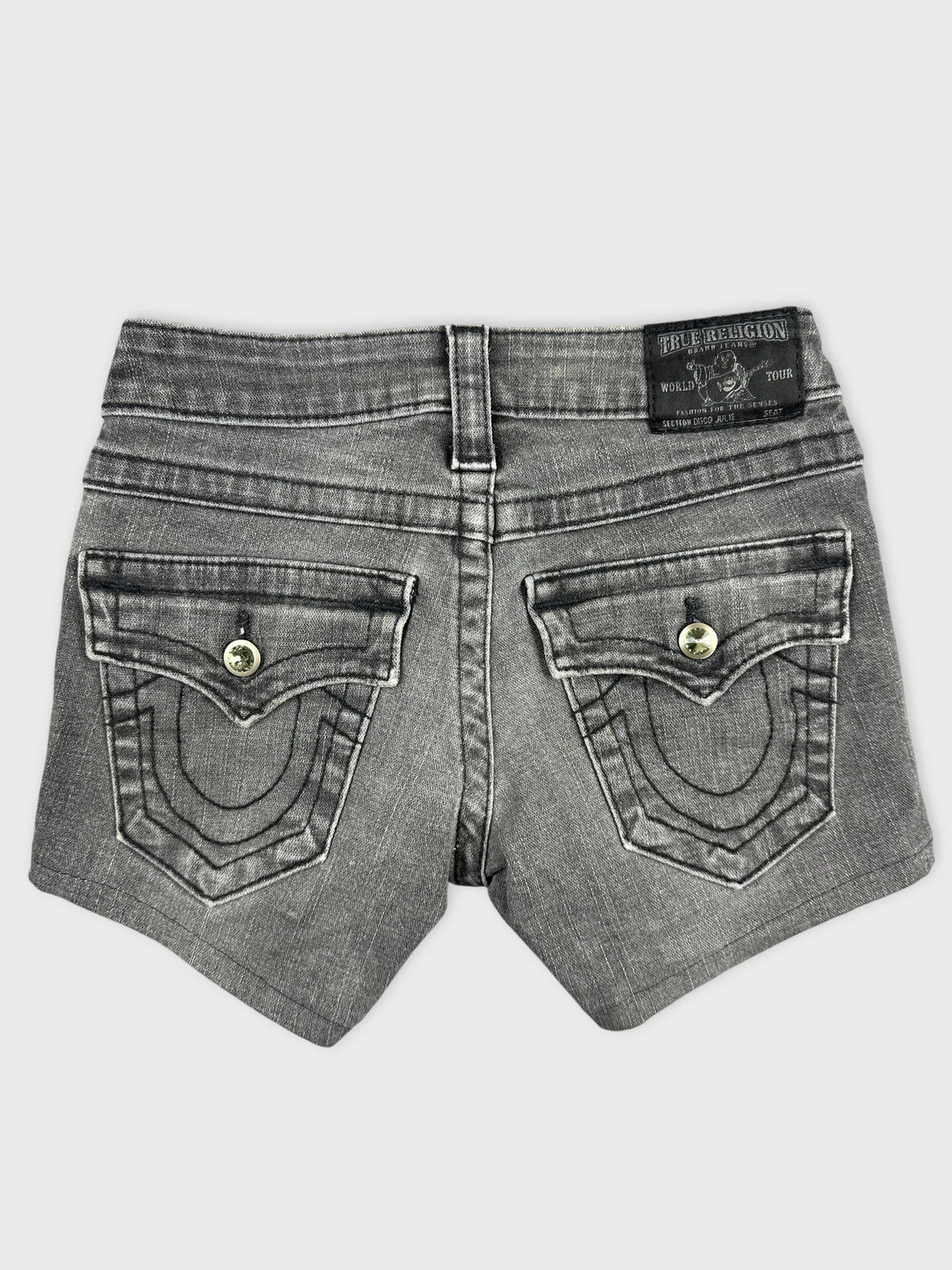 Back view of black denim shorts featuring unique pockets and stitching details.