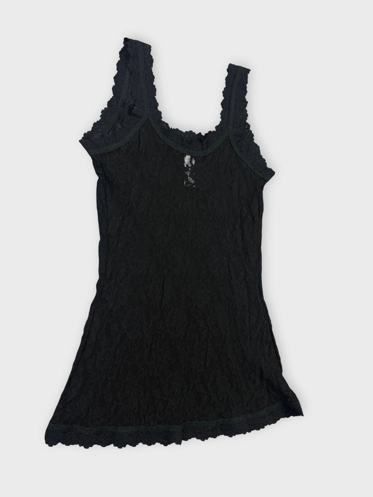 Detail view of a black lace tank top featuring scalloped trim.