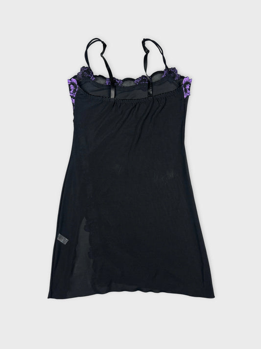 Back view of a black mesh tank top featuring purple floral trim.