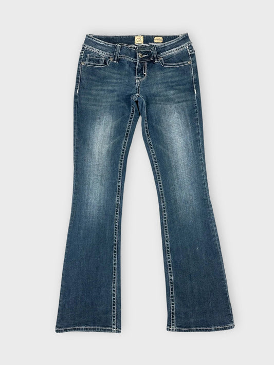Front view of dark wash denim flared jeans with classic pockets.