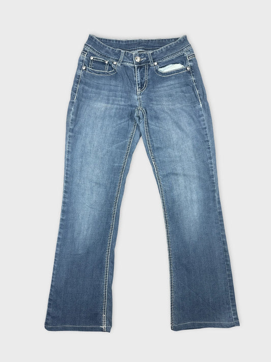 Back view of blue flare jeans featuring contrasting stitching details.