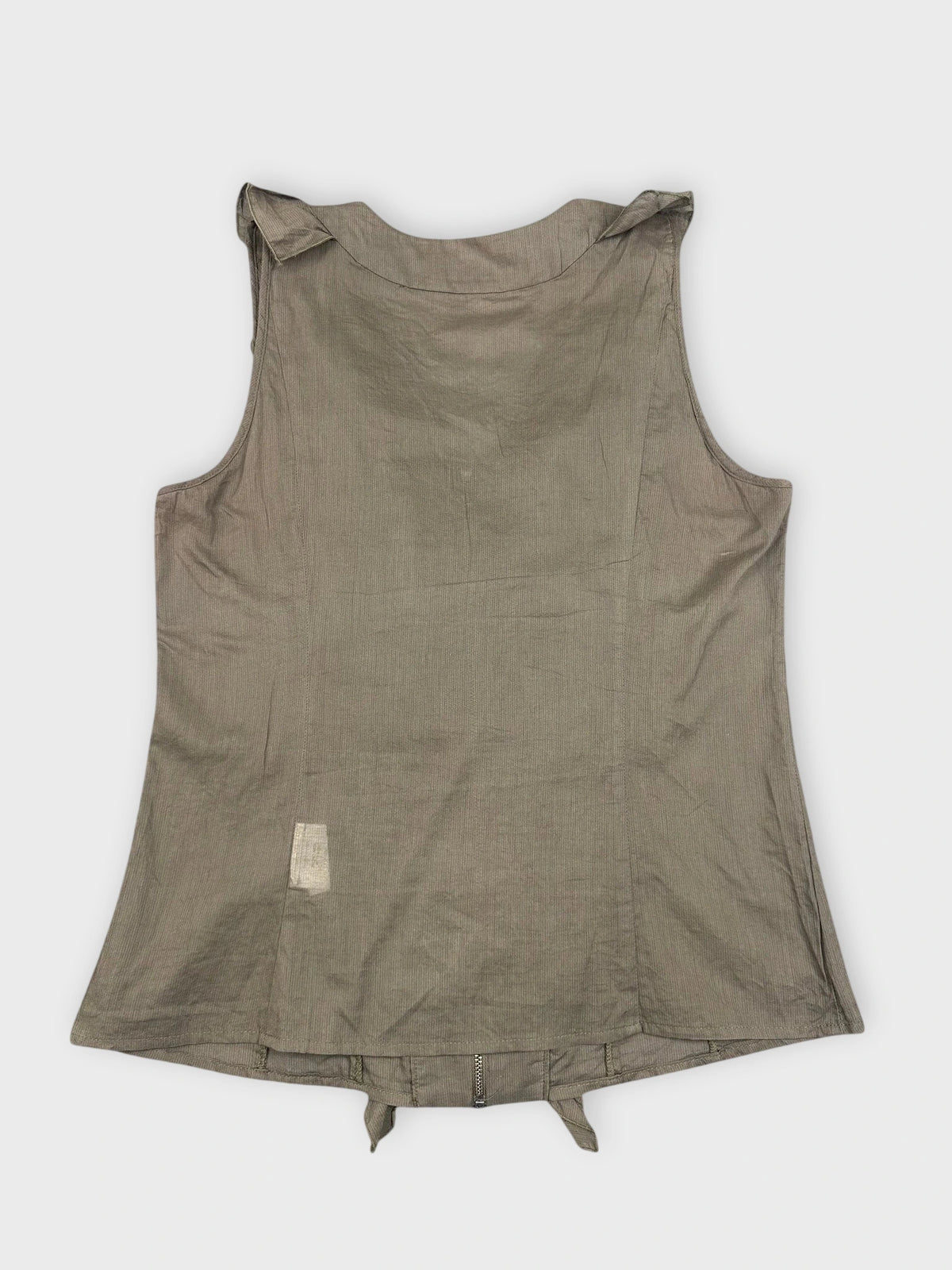 Back view of a green ruffle zip top with loose ruffles.
