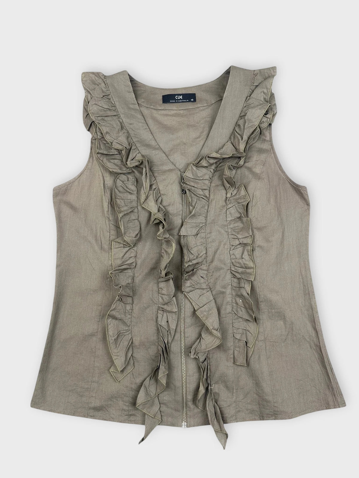 Detail view of a green ruffle zip top featuring layered ruffles.
