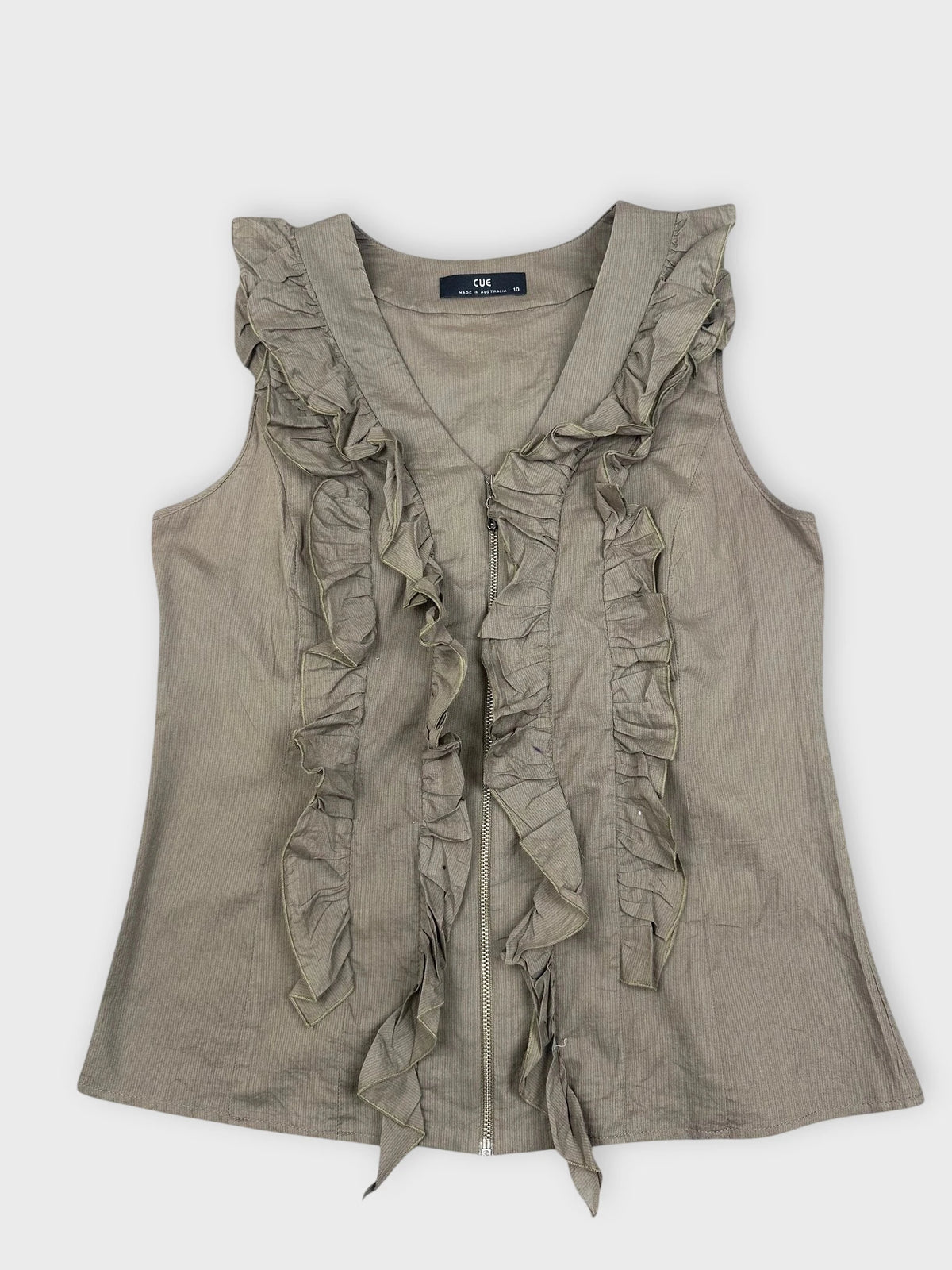 Front view of green ruffle zip top featuring loose ruffles along the zipper.