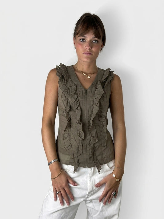 Front view of a brown ruffle zip top with layered details.