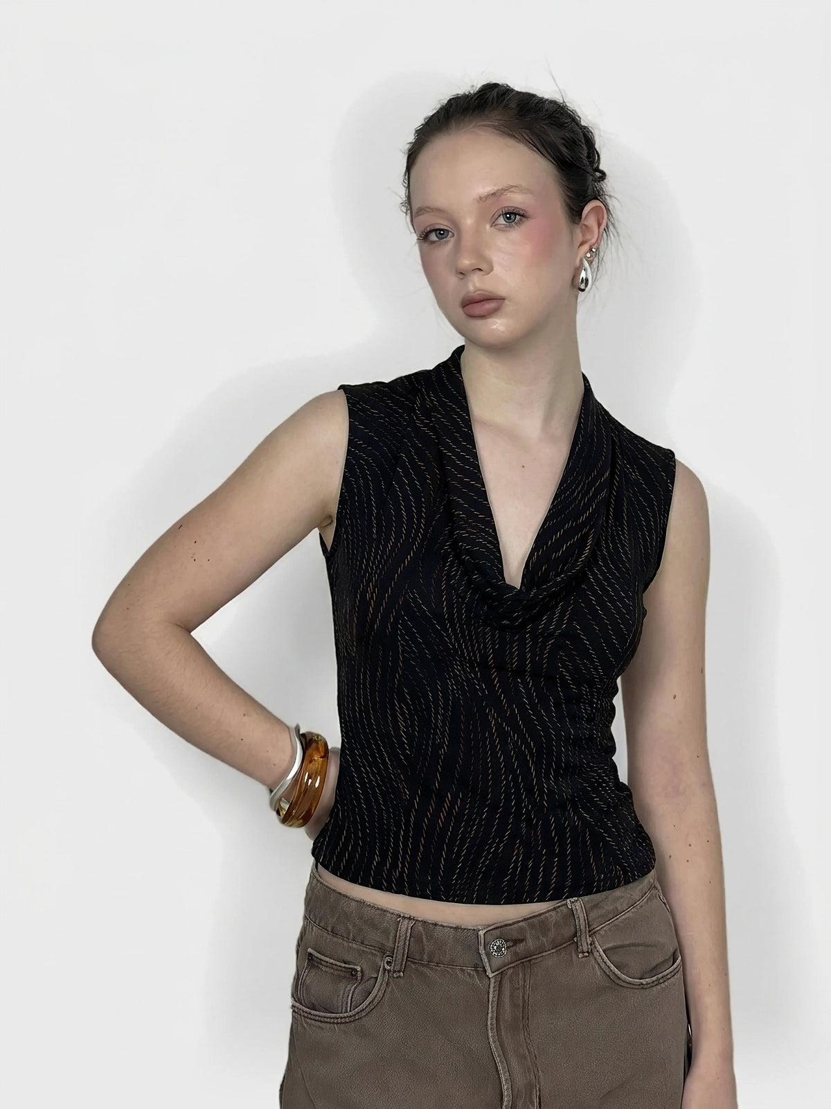Front view of a black cowl neck top with a textured wave pattern.