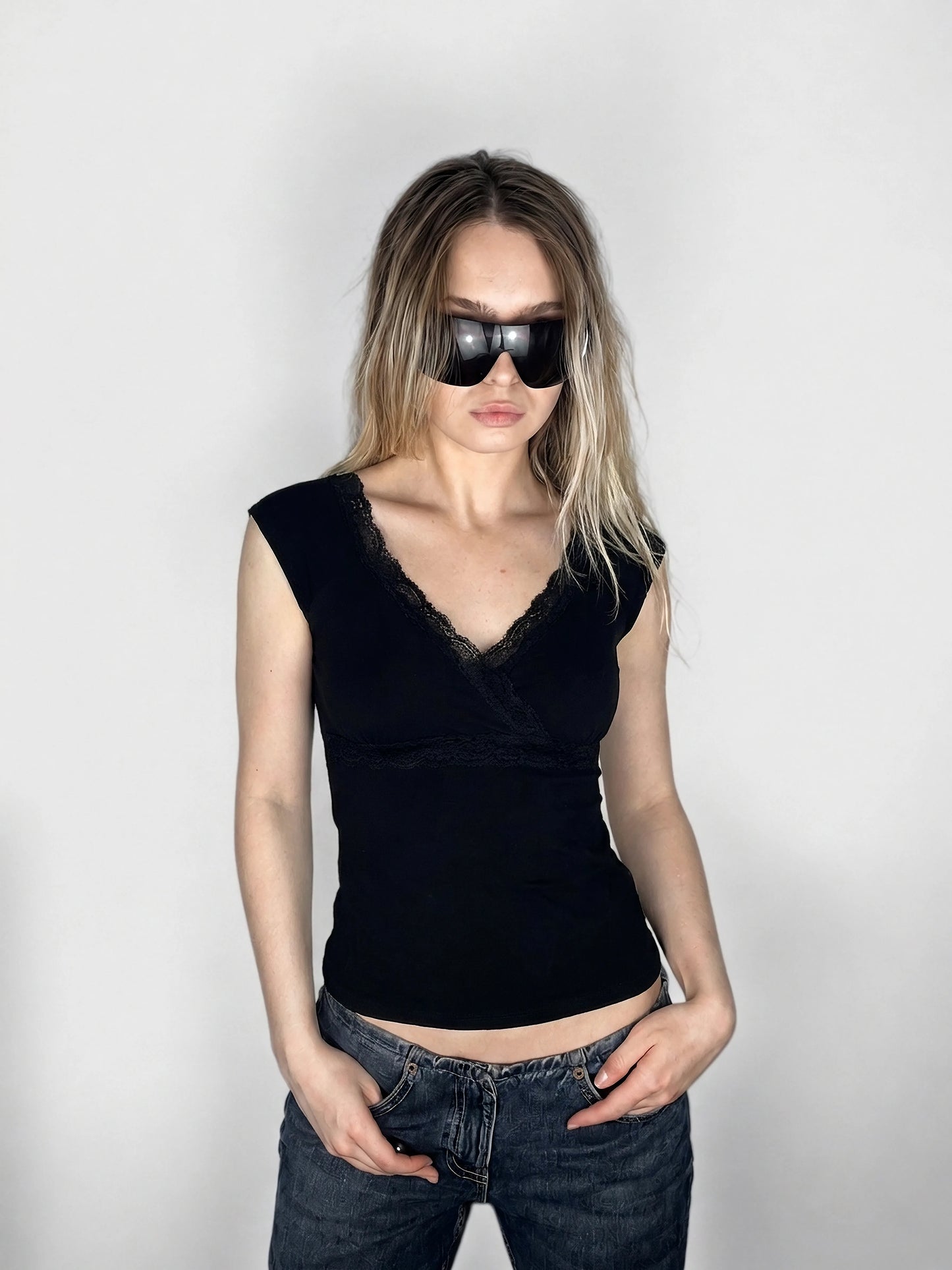 Elegant black top with lace trim, shown in front view.