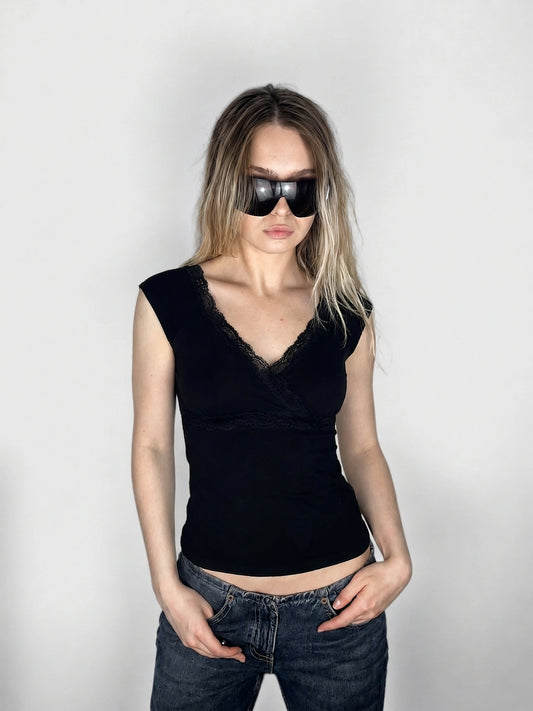 Elegant black top with lace trim, shown in front view.