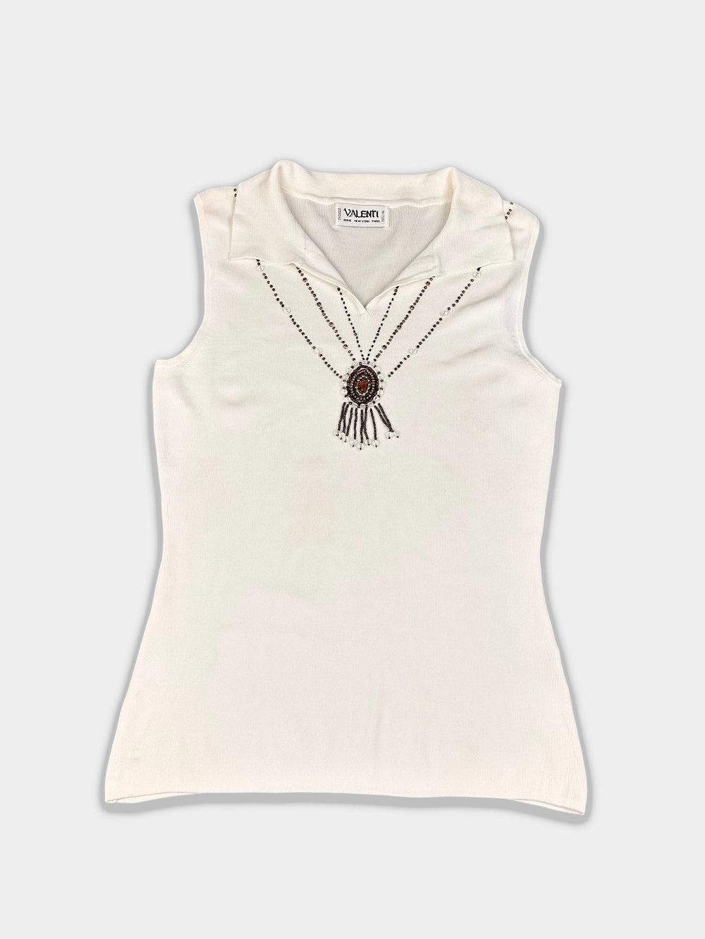 Elegant sleeveless top in cream with beaded details front view