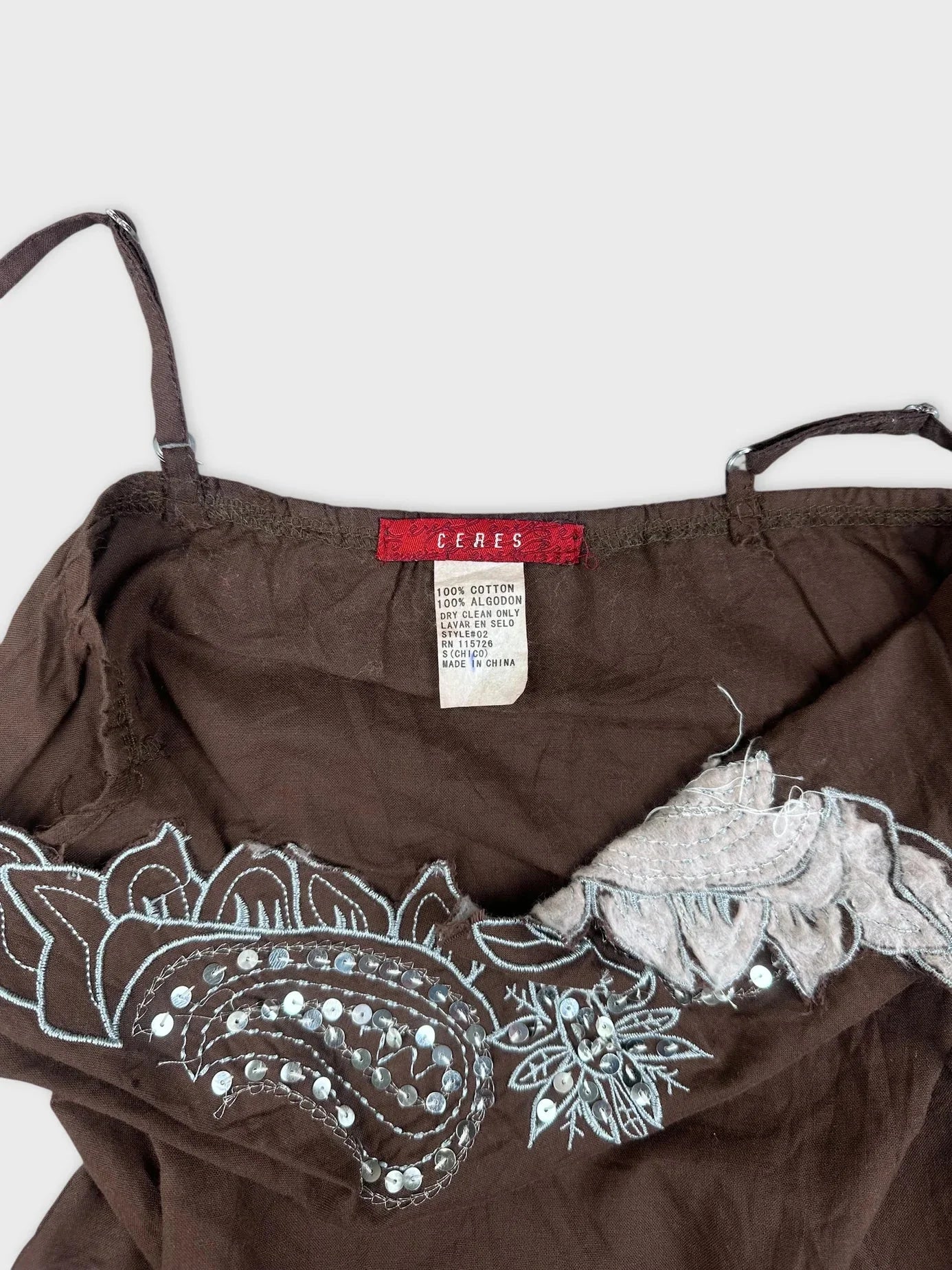 Detail view of brown embroidered cami top featuring decorative stitching and sequins.