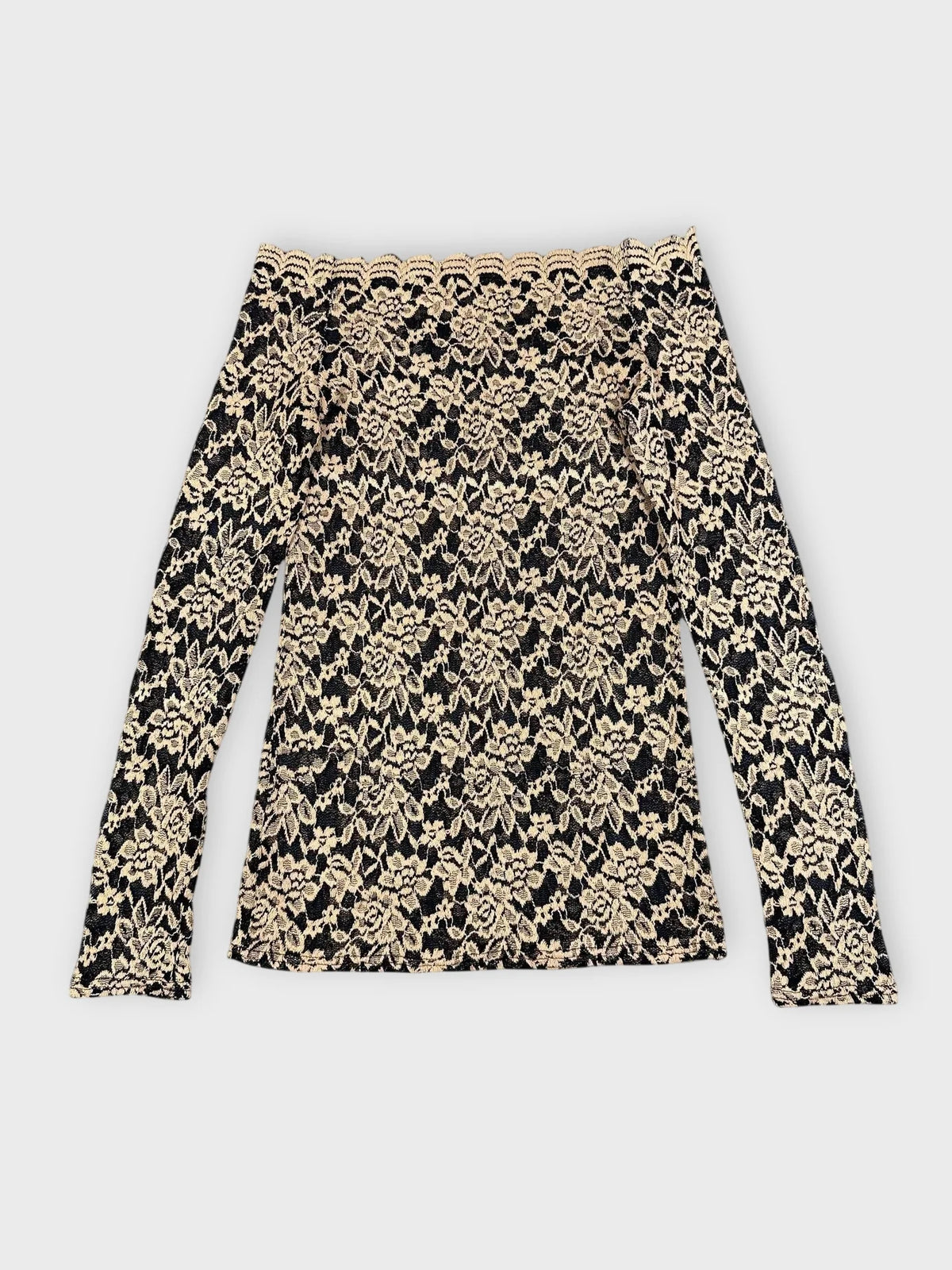 Back view of black and beige floral lace bardot top with long sleeves.