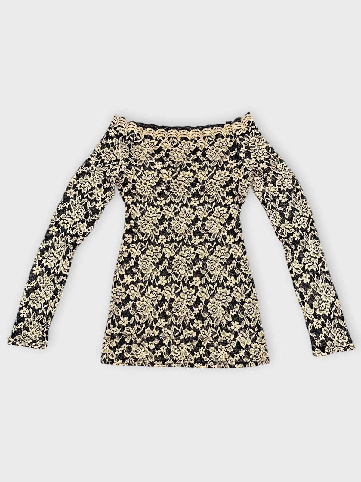 Detail view of black and beige floral lace Bardot top with off-shoulder design.