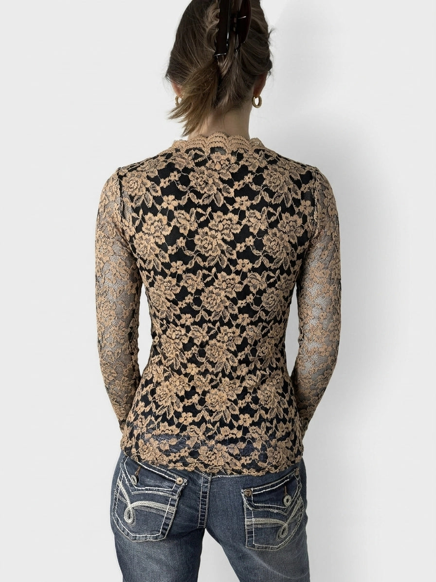Back view of a black and beige floral lace bardot top featuring a scalloped neckline.