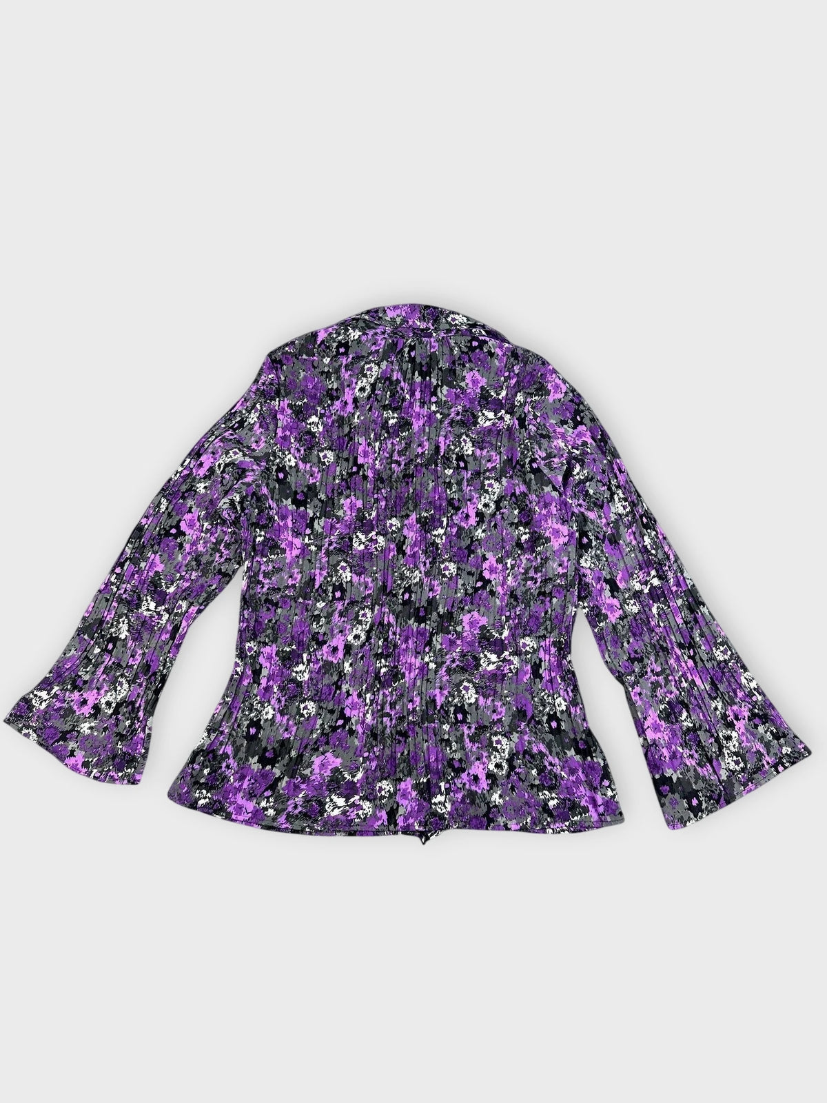 Back view of a floral ruffle blouse in purple with bell sleeves.